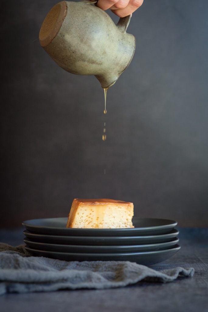 Starting to drizzle some caramel sauce over a Peruvian Flan