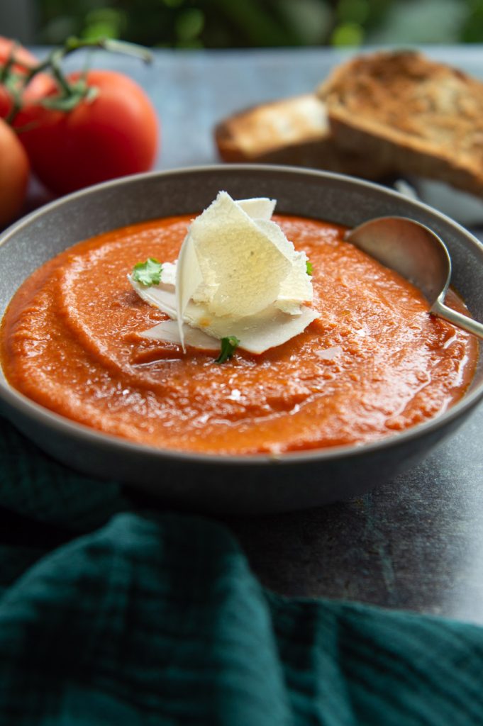 homemade tomato soup serve with parmesan cheese and bread